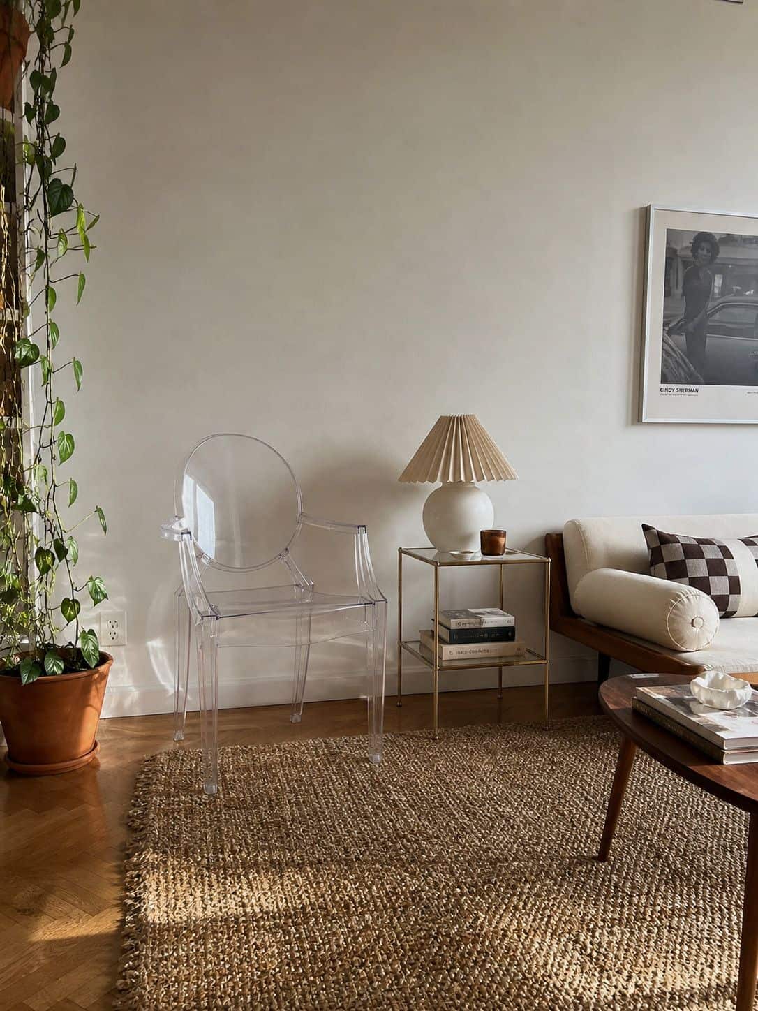 Clear acrylic accent chair and side table keeping a small apartment visually open