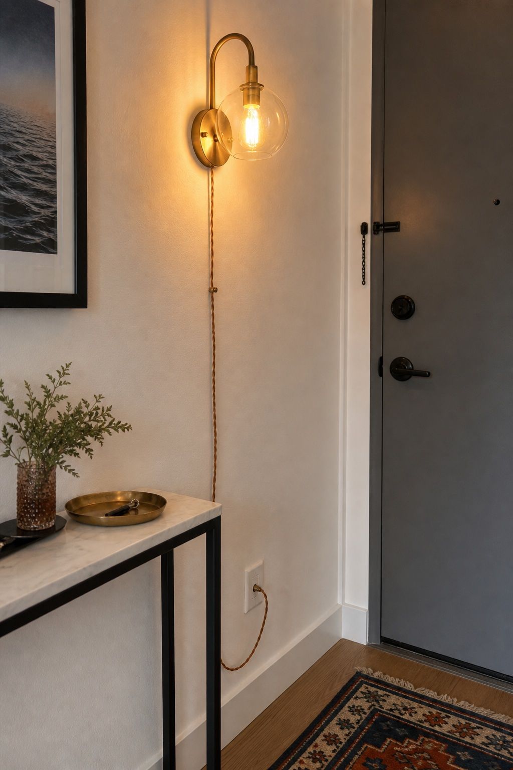 Add a Statement Light or Plug-In Sconce for Intentional Mood small apartment idea for Top 18 Small Apartment Entryway Ideas When You Have No Foyer.