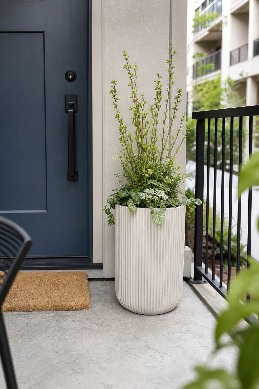 Lead With a Fluted or Ribbed Planter small apartment idea for Top 16 Avant-Garde Front Porch Spring Decor Ideas for Apartments and Small Outdoor Spaces.