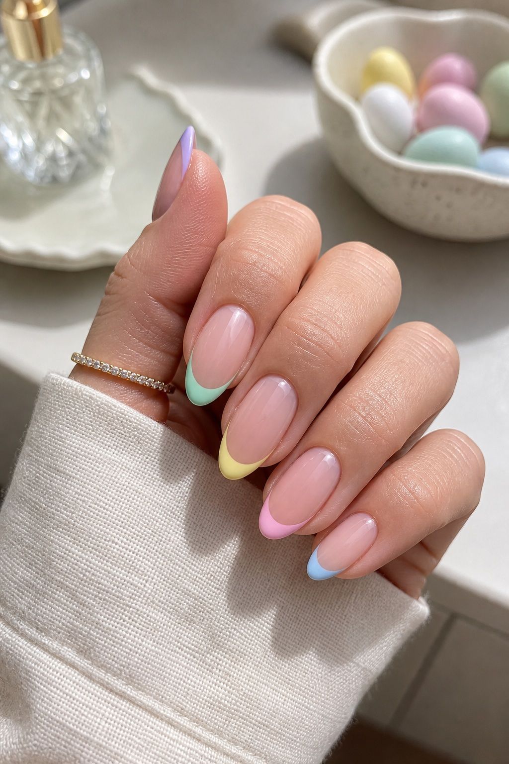 Elevated Pastel French Tips Easter nail design on a realistic hand.