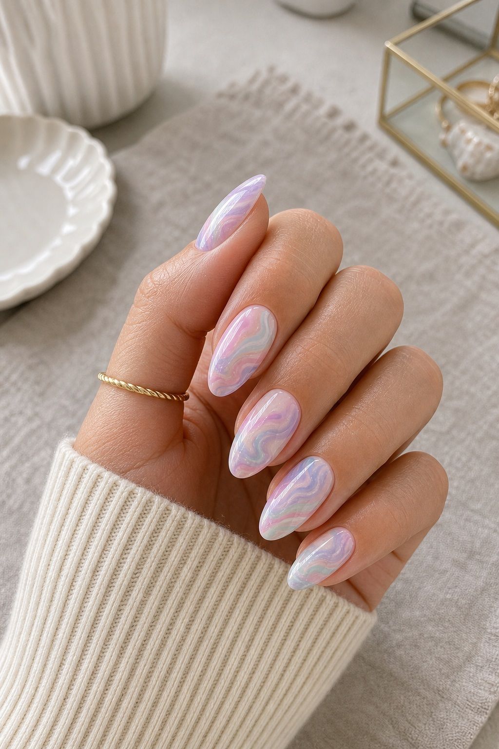 Marbled Pastel Swirls Easter nail design on a realistic hand.