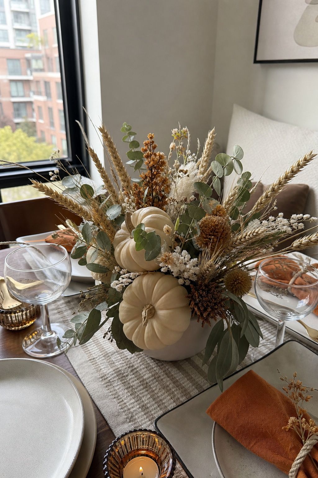 Pumpkin and Dried Floral Centerpiece small apartment idea for Top 20 Hosting Friendsgiving Ideas to Create a Cozy and Stylish Celebration.