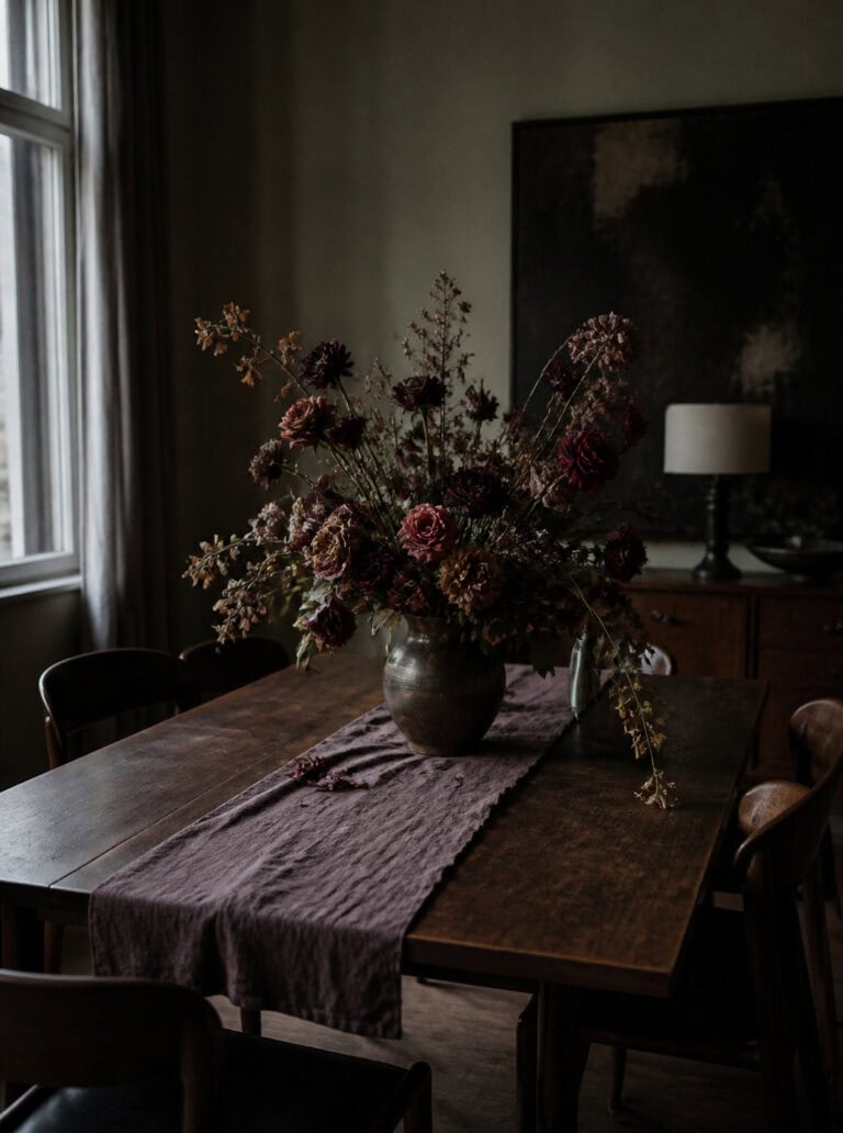 Dark floral halloween centerpiece ideas on a rustic wooden table