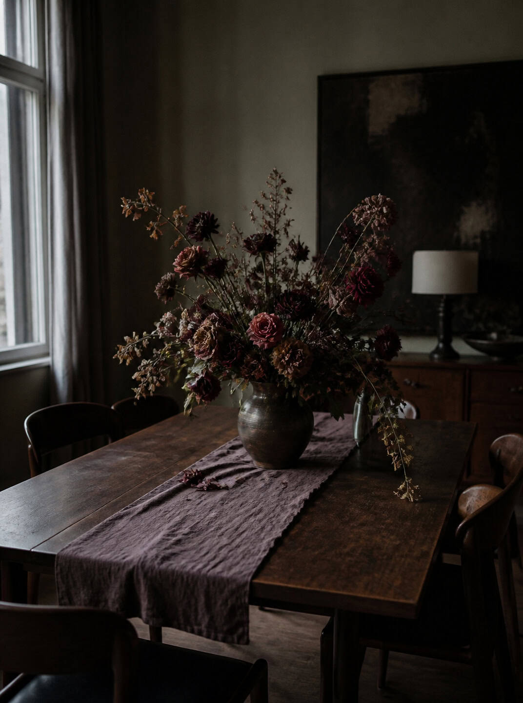 Dark floral halloween centerpiece ideas on a rustic wooden table