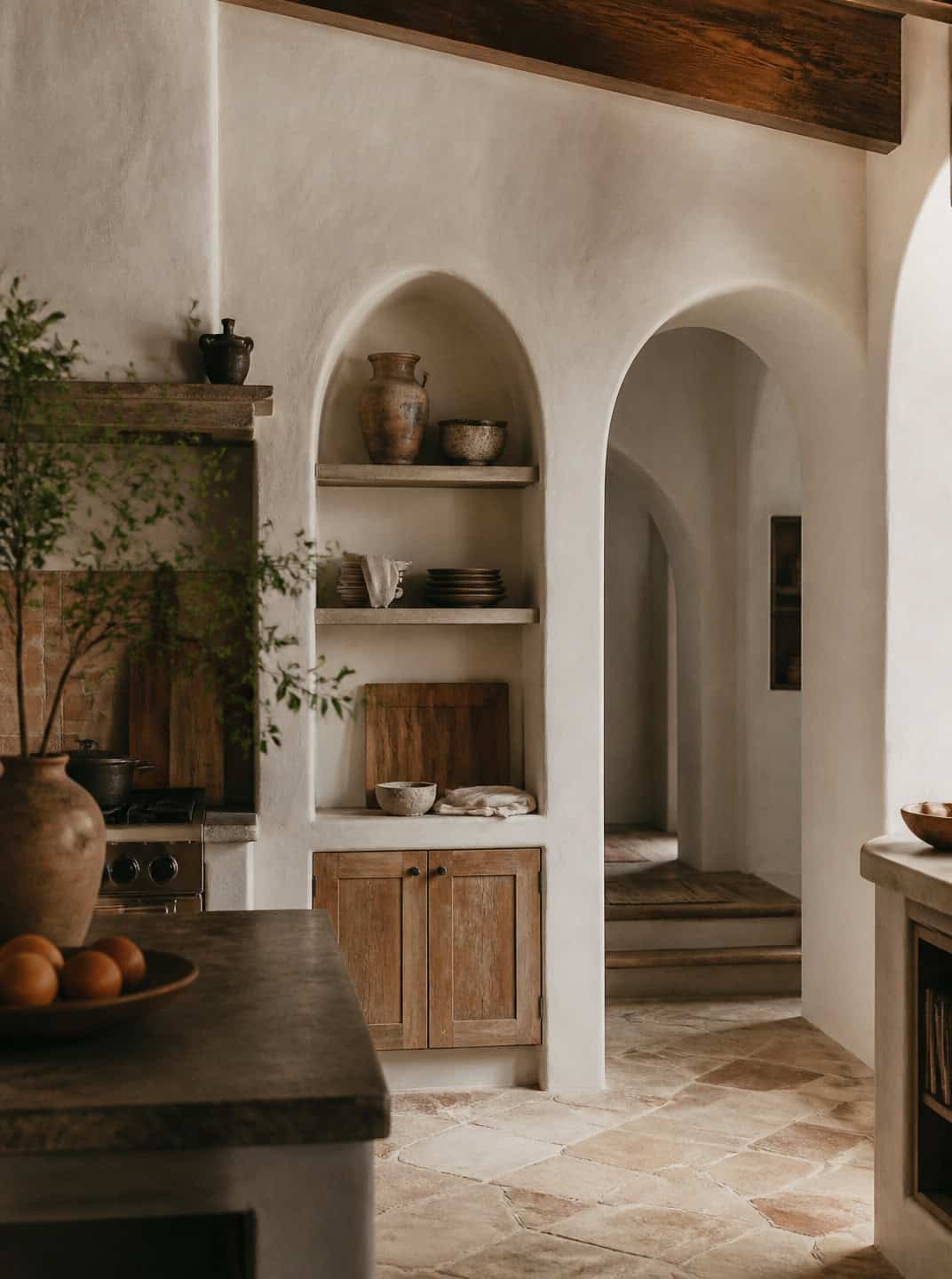 Spanish Mediterranean kitchen with arched niches, rustic wood cabinets, and terracotta floors.