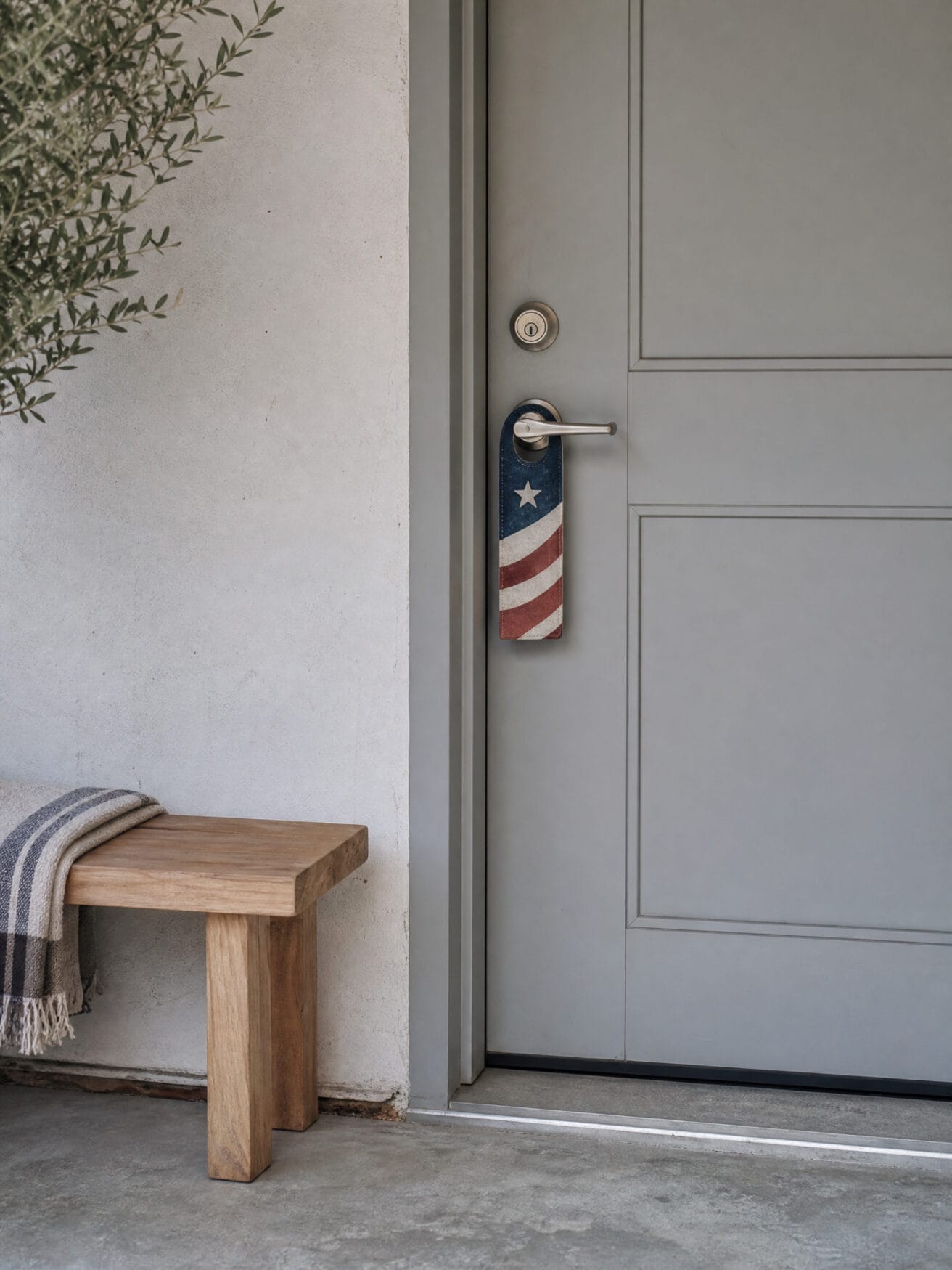 American flag door hanger on a gray front door, a summer door hanger idea.