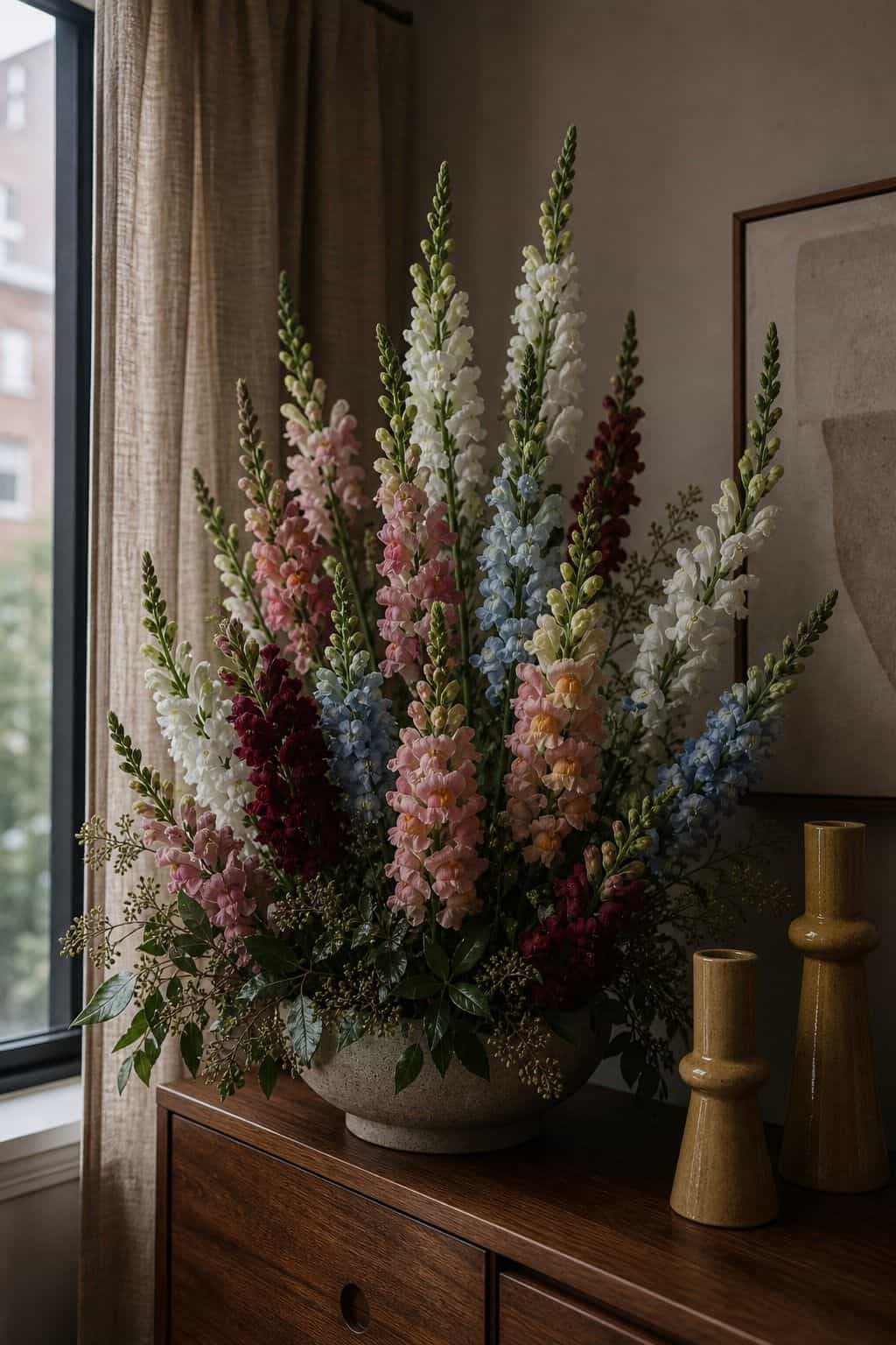 Tall snapdragons adding vertical drama to a summer wedding floral arrangement