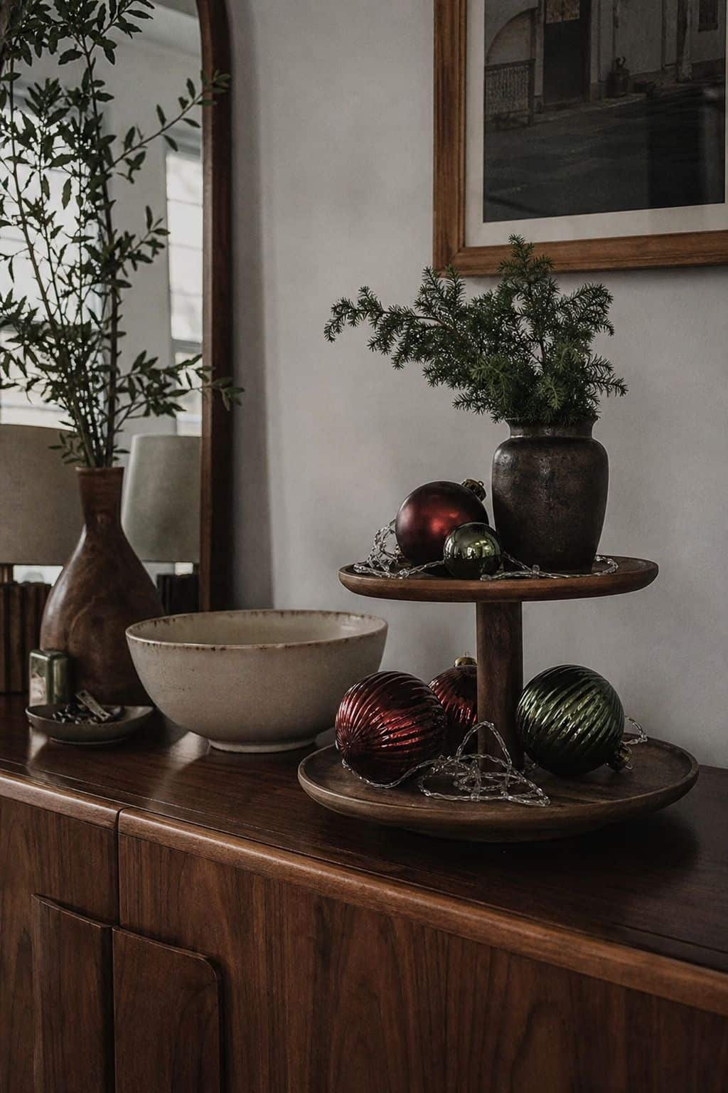 Christmas tiered tray with red and green ornaments and delicate string lights