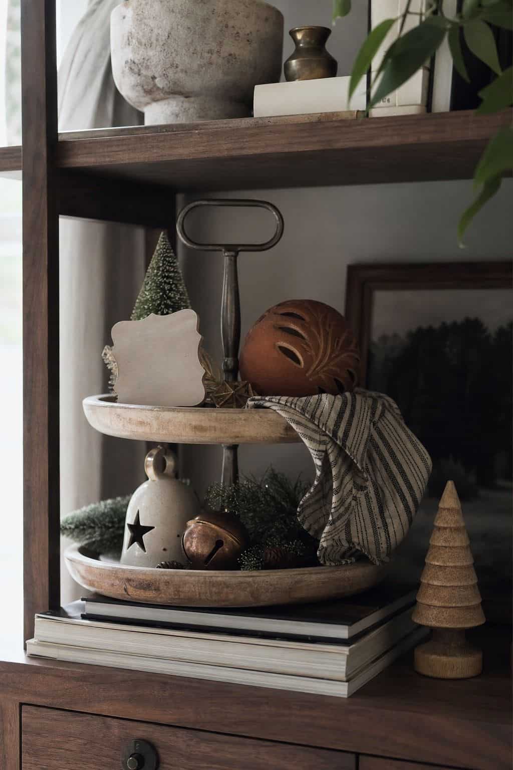 Christmas tiered tray with a small festive sign shape, mini tree, snowman, and greenery