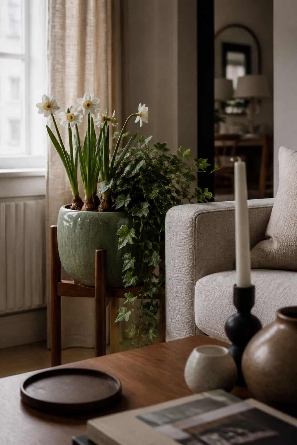 Potted spring bulbs and ivy on a walnut plant stand for Easter living room decor