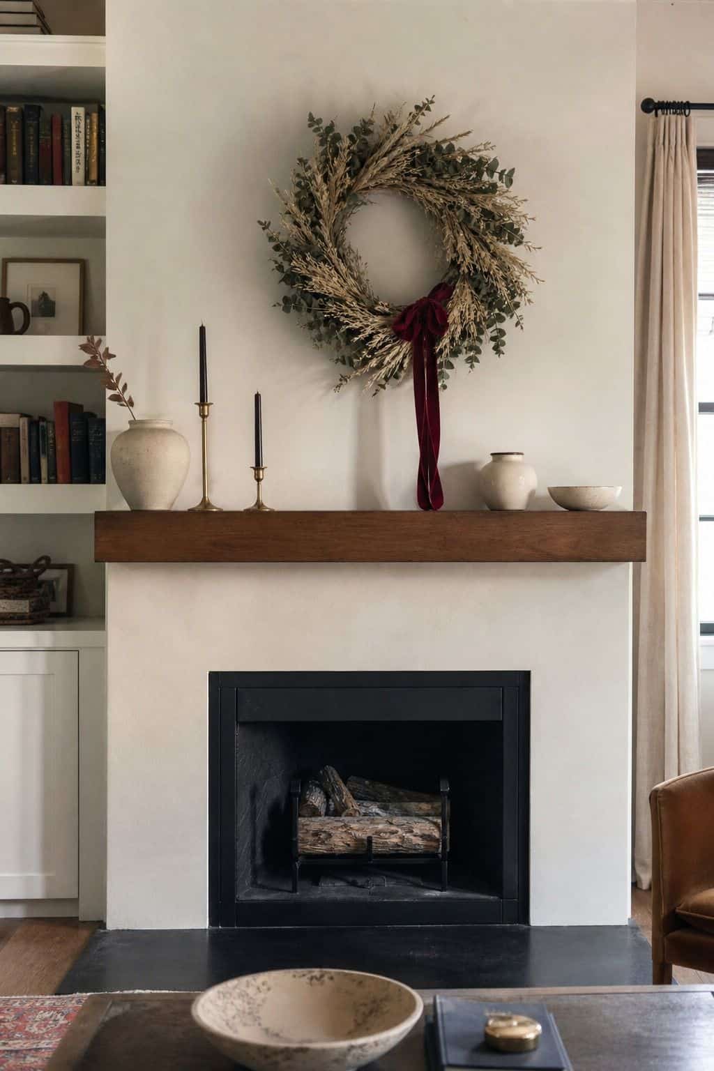 Dried wheat wreath above a walnut mantel for Thanksgiving fireplace decor