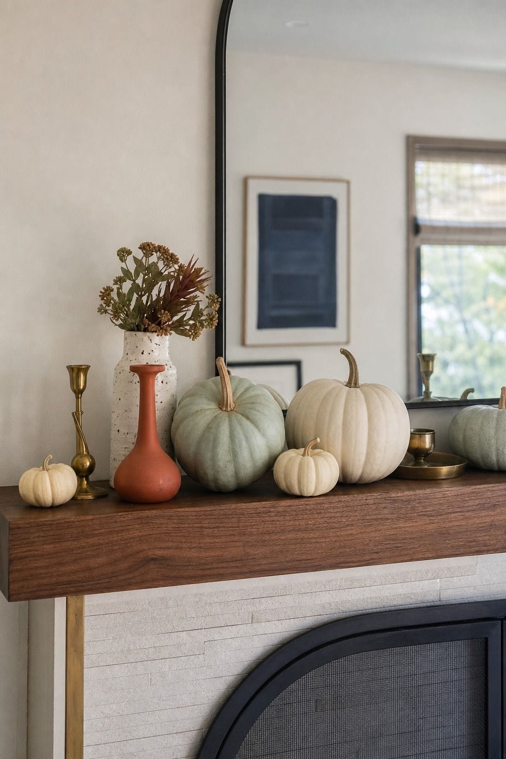 Cream and pale blue mini pumpkins layered across a walnut fireplace mantel