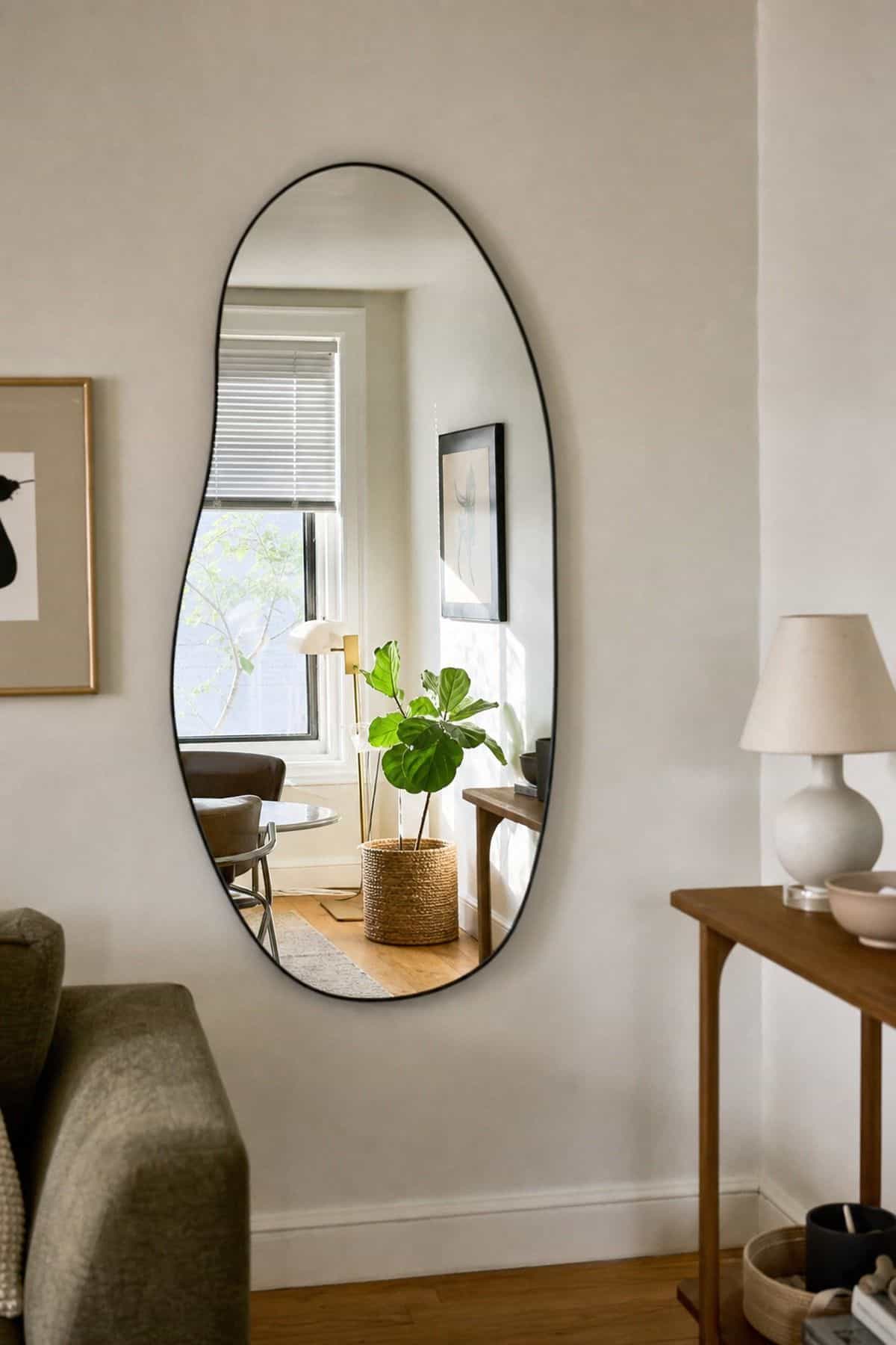 An asymmetric arched mirror in a small apartment living room