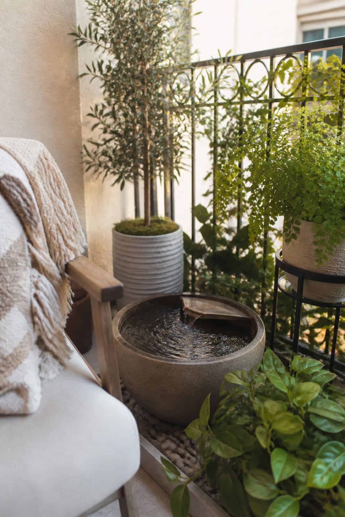 Small outdoor patio idea with incorporate a small fountain or water feature for tranquility