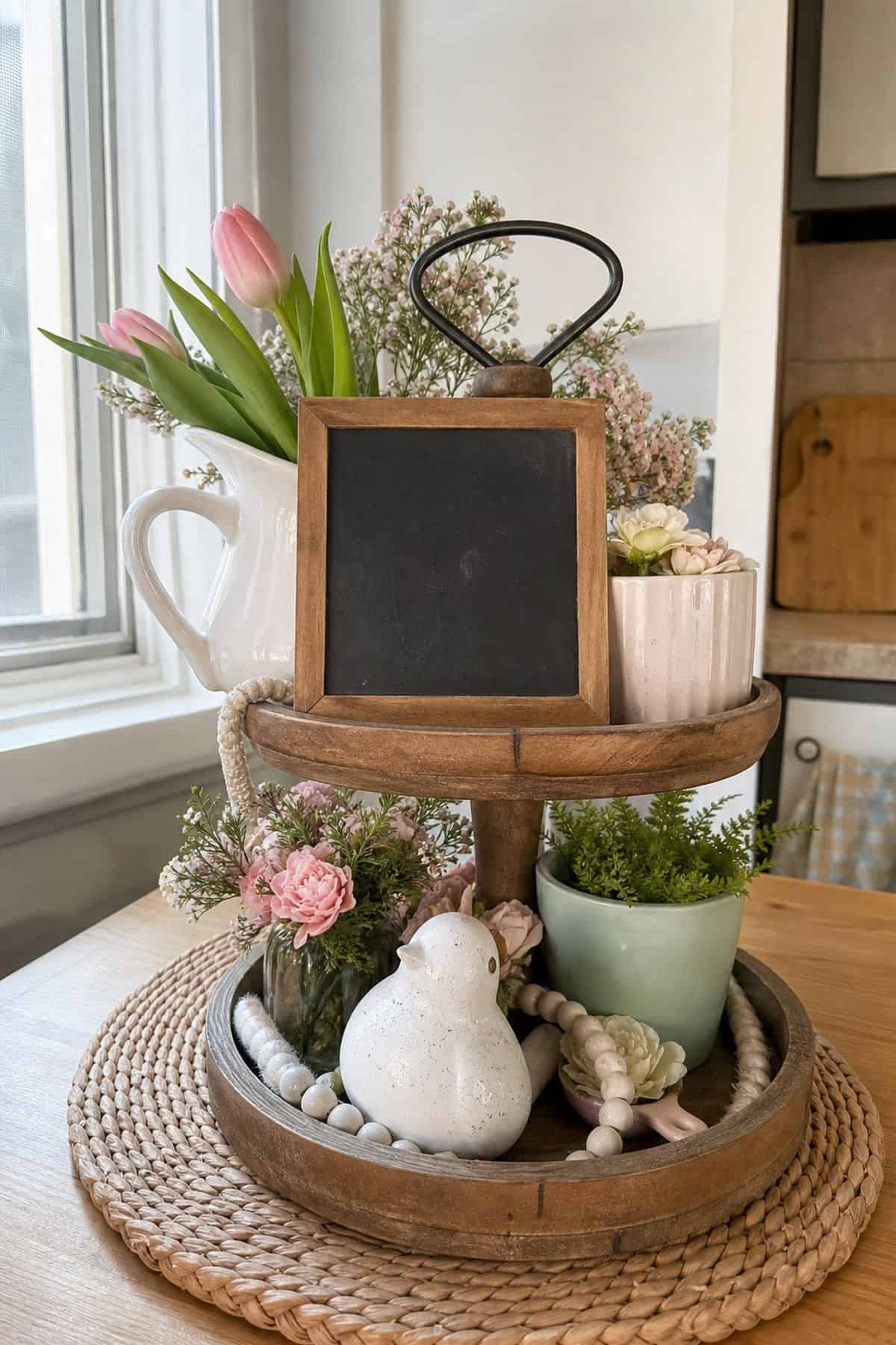 Place a Small Chalkboard Sign With a Spring Greeting styled on a spring tiered tray in a small apartment